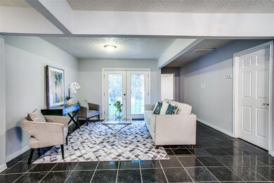 Alternate view of living room. French doors lead t