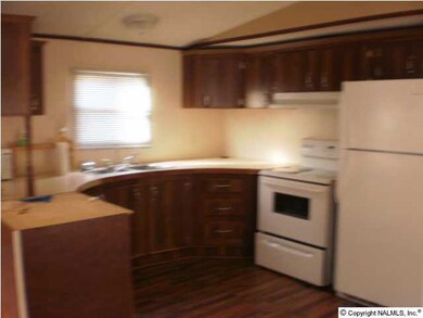 Kitchen includes eat-in area and is open to the living room. The refrigerator and microwave convey with the sale.