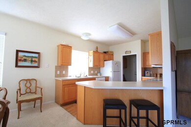 Open and airy kitchen with adjoining main floor laundry.