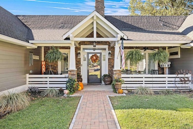 Doorway to property featuring covered porch, a yar