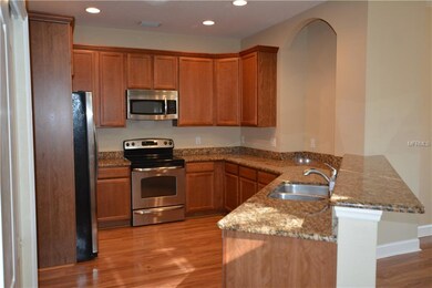 WOOD CABINETRY, GRANITE COUNTERS, PORCELAIN FLOOR 