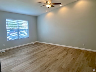 Spare room featuring light wood-style floors, recessed lighting, and ceiling fan
