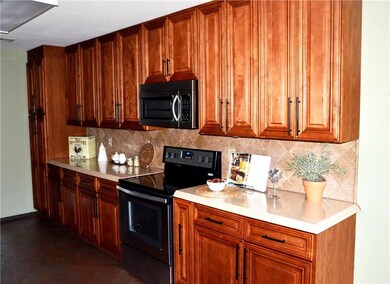 Lots of cabinets in the kitchen with Cultured Marble Counter Tops. Brand new Stove and Built-in Microwave Oven.