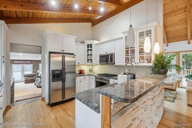 Stylish kitchen plenty of cabinets, stainless steel appliances, snack bar.