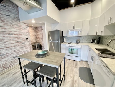 Kitchen with entry to the left. Wine frighted/bar