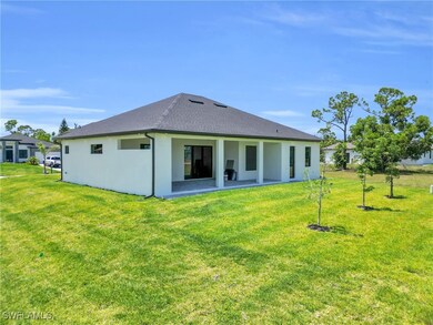 Rear view of house featuring a lawn, a shingled ro