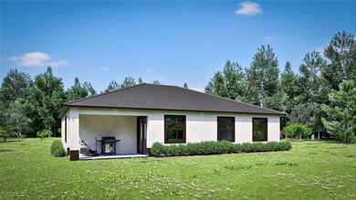 Rear view of house featuring a lawn and stucco siding