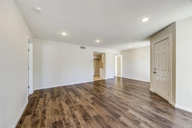 view from living room to kitchen and bedrooms on e