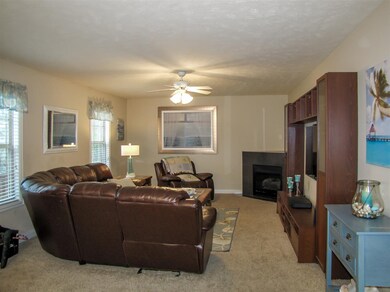 Living room with corner gas fireplace.