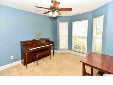 TWO SECONDARY BEDROOMS HAVE CARPET, CEILING FANS, AND PLENTY OF NATURAL LIGHT. THIS BAY WINDOW OVERLOOKS THE FRONT LAWN.