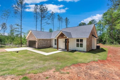 Ranch-style home featuring board and batten siding