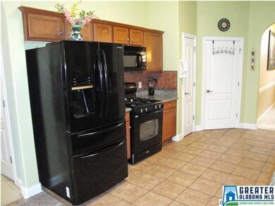 Lovely tile kitchen with granite counters, gas ran