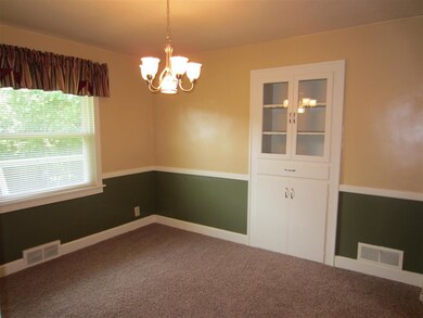 The charming Dining Room has chair rail and built-