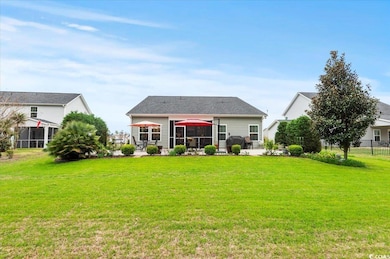 Rear view of property featuring fence, a patio, an