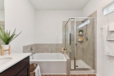 Full bath featuring a stall shower, a garden tub,