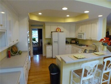 Bright kitchen with hardwood floor, gas range, cor