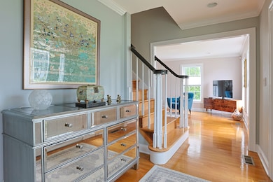 Foyer with access to second floor, living room and dining room. Also equipped with recessed lighting.