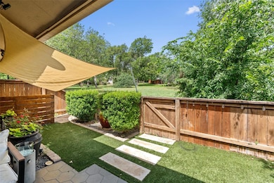 View of yard featuring a gate and view of wooded 