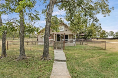 Bungalow-style house featuring a fenced front yar