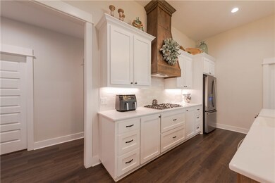 Kitchen featuring white cabinets, stainless steel