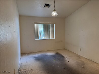 Empty room with carpet flooring, visible vents, an