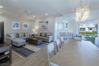 Living room with ceiling fan with notable chandeli