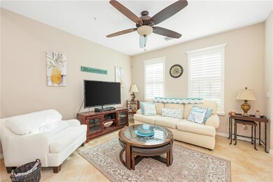 Living room featuring ceiling fan and light tile p