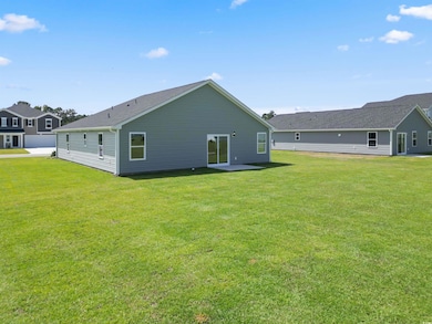 Back of house featuring a yard and a patio
