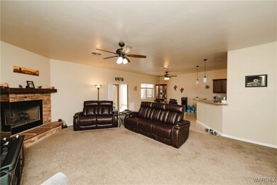 Carpeted living room featuring a fireplace and cei