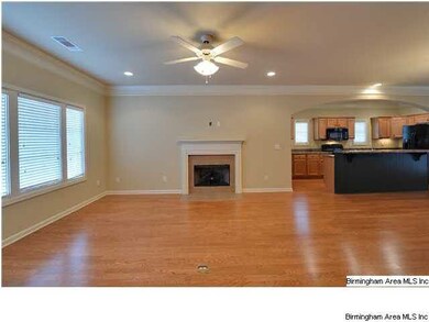 ANOTHER VIEW OF THE FAMILY ROOM SHOWING THE KITCHE