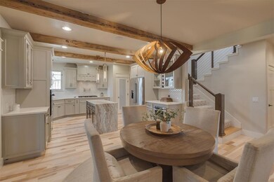 Dining space featuring stairway, light wood-type f