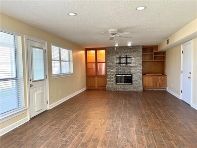 Living room features wood burning fireplace, built
