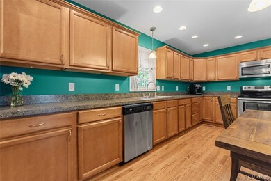 Kitchen has double sinks,recessed lighting & stain