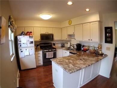 White shaker cabinets, granite counters, subway ti