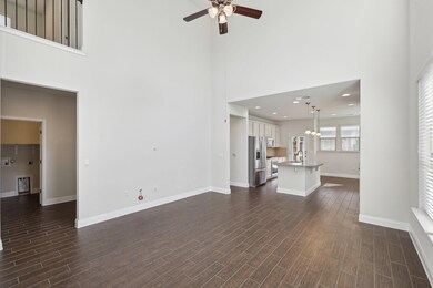 Unfurnished living room featuring a towering ceil