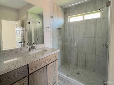 Bathroom with vanity and a shower stall