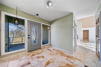 Foyer featuring a textured ceiling