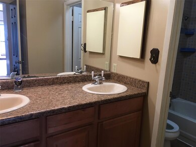 Full bathroom featuring toilet, double vanity, a 