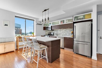 Kitchen featuring a kitchen breakfast bar, appliances with stainless steel finishes, dark brown cabinetry, a center island, and tasteful backsplash