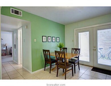 Dining Room. With access to the back, this tile kitchen sports ample cabinet space, with undermount lighting, and a breakfast area perfect for that morning cup of coffee.