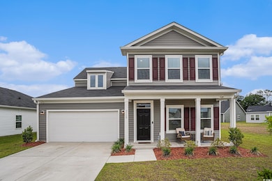 View of front of home with a porch, a garage, a front lawn, driveway, and roof with shingles