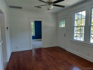Living area has refinished hardwood floors, new ceiling fan with light, freshly painted