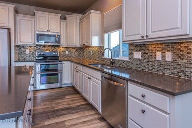 Stylish tiled backsplash with under counter lighti