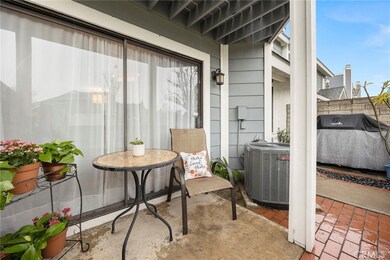 The front patio offers a peaceful setting for morning coffee or small gatherings.