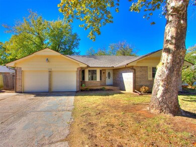 Ranch-style home with a front yard and a garage