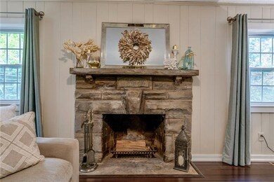 Gorgeous log burning stone fireplace is the focal 