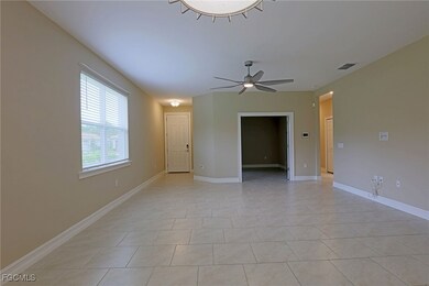 Empty room with ceiling fan and light tile pattern