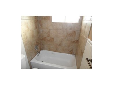 New bath tub surrounded by tile