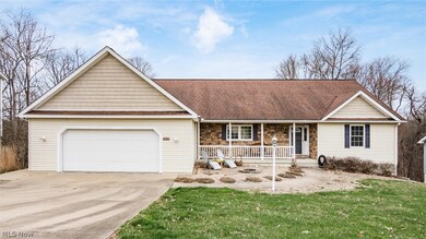 Ranch-style home featuring a garage, a front lawn, and a porch