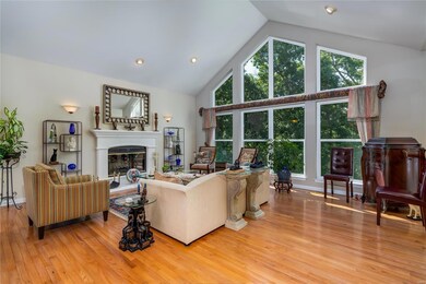 Great room features vaulted ceiling, wood floors, 